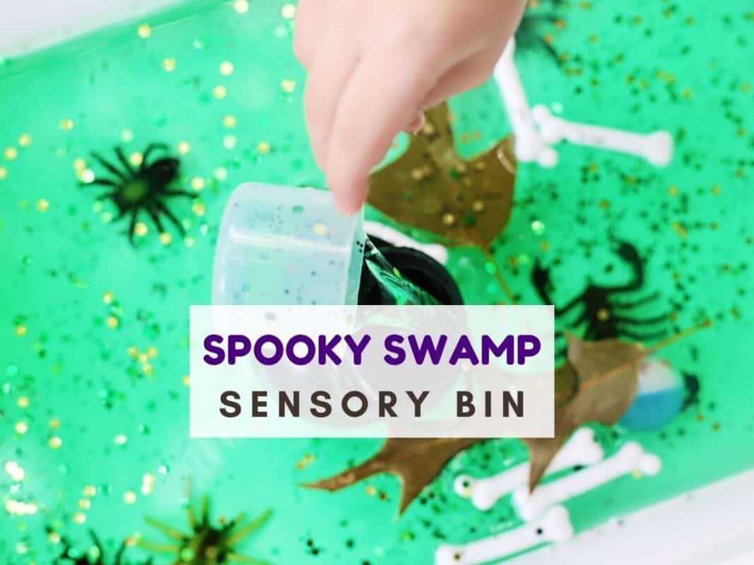 Spooky swamp sensory bin with green water, glitter, toy spiders, bones, and leaves, with a child pouring liquid from a clear cup. Overlay text reads Spooky swamp sensory bin