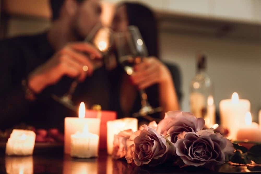 candles and flowers with a couple in the background