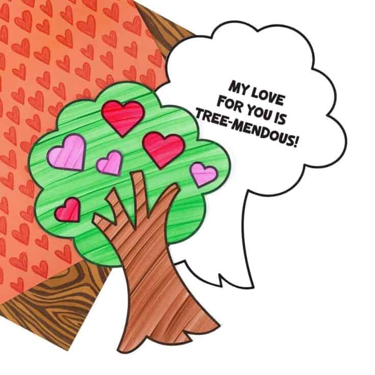 A hand-drawn paper tree craft with green leaves and a brown trunk is decorated with red and pink hearts, alongside a large speech bubble that says, "MY LOVE FOR YOU IS TREE-MENDOUS!" in bold black letters. The background features heart and woodgrain patterned paper, enhancing the Valentine’s Day theme.